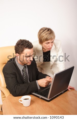 Man and woman busy with work in office