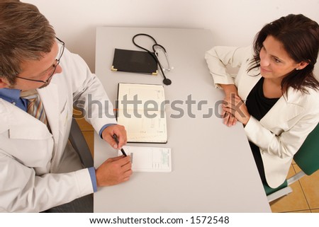At the doctor\'s office - doctor explaining diagnosis to his female patient