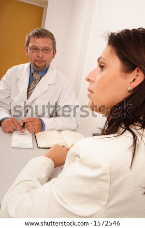 At the doctor\'s office - doctor explaining diagnosis to his female patient