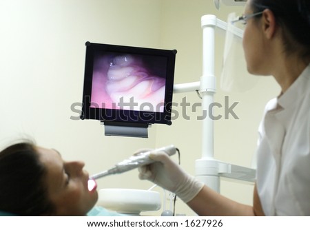 Dentist watching patient\'s teeth at the screen - focus on monitor