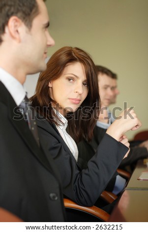 A woman lawyer at a conference table with three other male attorneys.