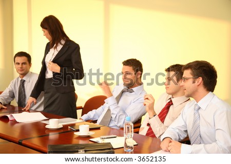Informal business meeting of five persons - standing woman interview