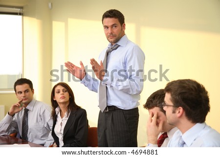 Group of business listening to their boss during informal meeting