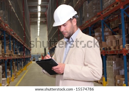 worker counting stocks and making notes