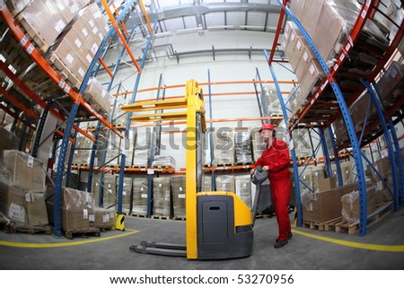 worker in red uniform at work in warehouse in fish-eye lens