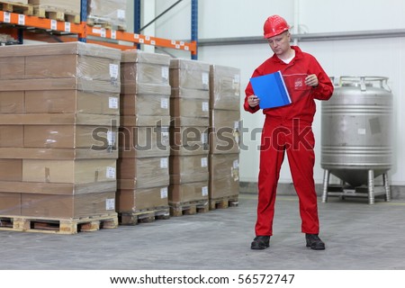 Worker counting stocks in a company warehouse