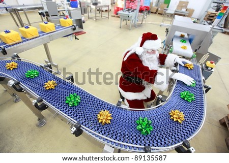 santa claus as a quality control manager at christmas ornament production line in factory