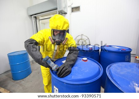 fully protected in yellow uniform,mask,and gloves professional dealing with chemicals