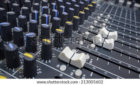 Close-up of music controls buttons of studio mixer