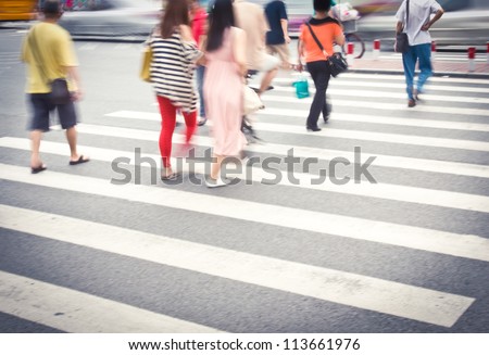 Busy urban street people on zebra crossing