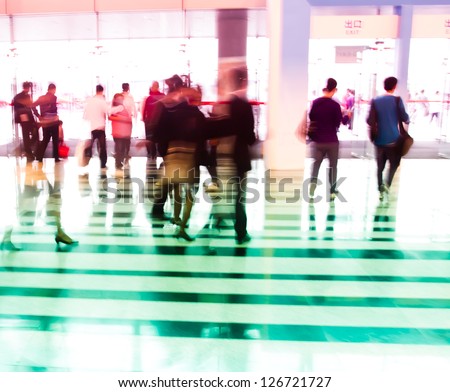 city business people walking in the lobby in intentional action blur and a colorful tint