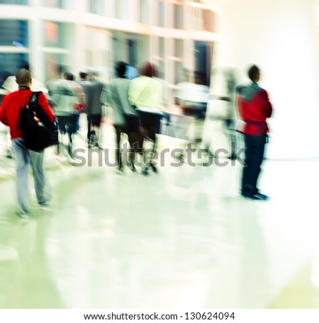 Intentional motion blur, city business people walking in the lobby