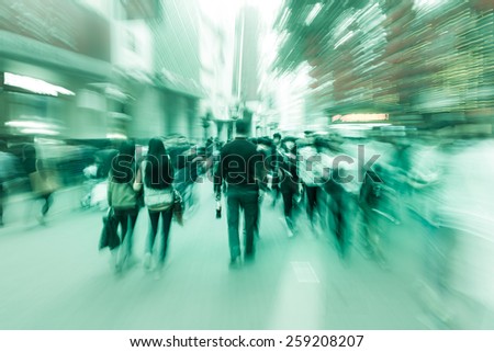 Pedestrians walking street during rush hour in urban business area