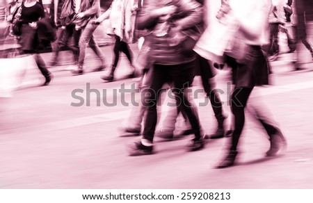 Pedestrians walking street during rush hour in urban business area
