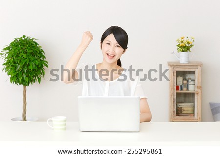 smiling Japanese woman with PC
