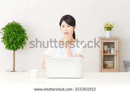 concerned Japanese woman with PC