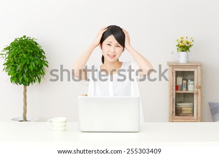 concerned Japanese woman with PC
