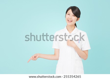 Japanese nurse pointing down
