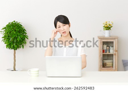weeping Japanese woman with PC