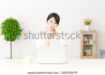 thinking Japanese woman with PC