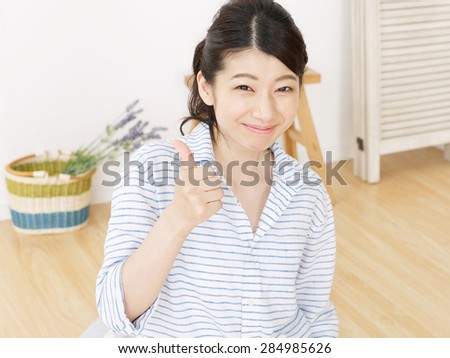 Japanese woman thumbs up sign gesture