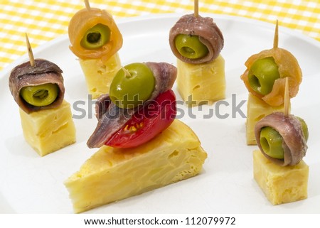 Delicious Appetizer Plate with Salmon, anchovies  and Olives. Spanish tortilla mounted