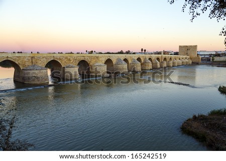 Sunset in the Roman bridge as it passes through the river Guadalquivir in Cordoba, Spain