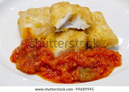 Fried salted codfish ready for a meal, Biscayan cod in, with tomato pisto