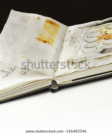 artistÃ?Â´s sketchbook with sketches in it, on black and white background