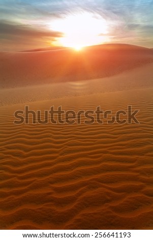 the sun and the hills of sand dunes