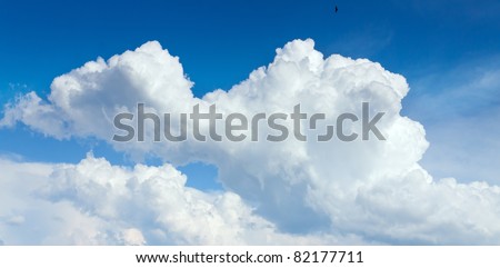 Huge cumulus clouds in the dark blue sky