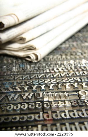 Typography workshop .Old Metallic Letters for Printing with daily newspaper