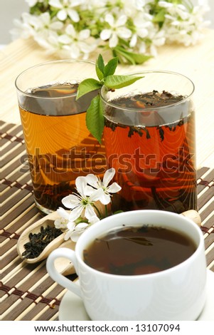 Fruit tea cup and dried tea leaves