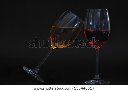 two wine glasses oblique one with yellow liquid