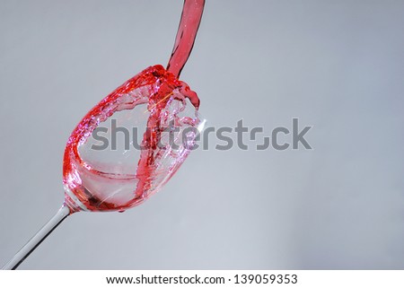 red liquid poured in the wine glass detail
