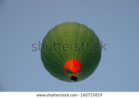 green balloon from below on blue sky in summer