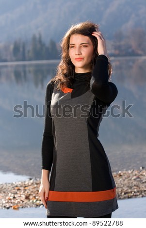 Pensive woman in dress on the lakeshore /pensive woman