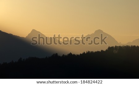 Forest and mountain silhouettes at sunrise