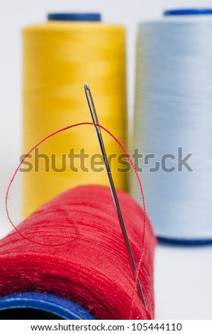 Red Bobbin and Needle Stuck on it