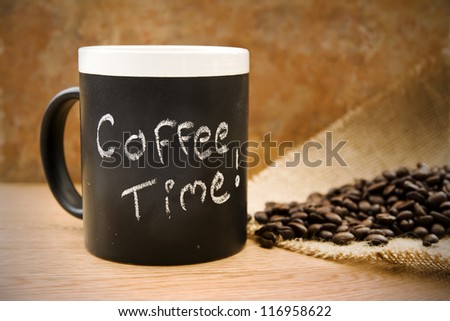 coffee time, mug with coffee beans & hessian on counter