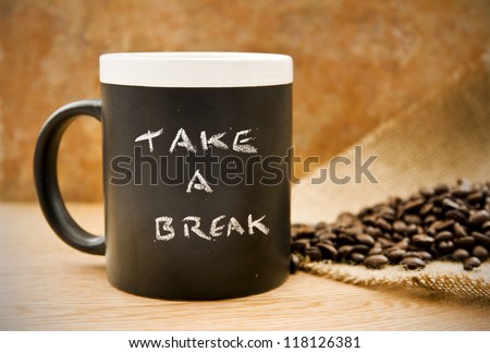 take a break, coffee mug with coffee beans & hessian on counter