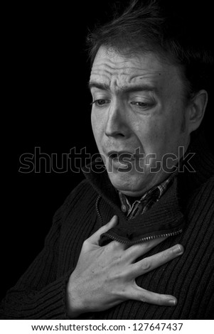 shock, heart attack. man with hand on chest black and white with copy space