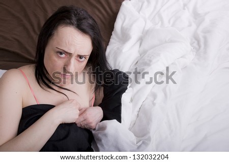 woman upset, crying in bed in bedroom landscape with copy space