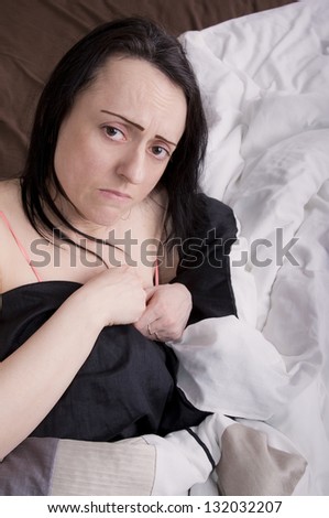 woman upset, crying in bed in bedroom portrait with copy space
