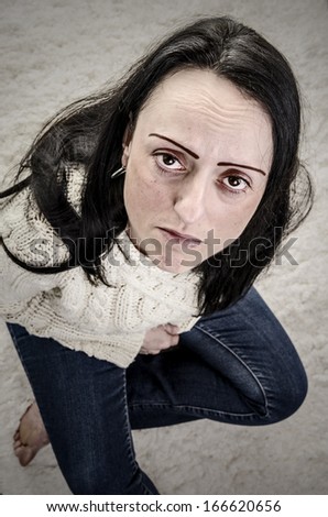 depression, woman sitting on floor thinking portrait