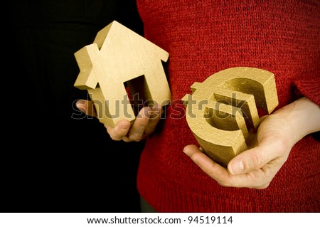 buying house, woman holding gold house and euro
