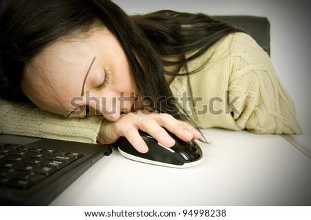 tired at work, woman asleep on computer keyboard and mouse in office