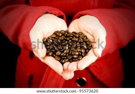 love coffee, woman holding coffee beans with hands in love heart shape