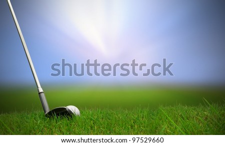 golf club hitting golf ball along fairway towards green with copy space