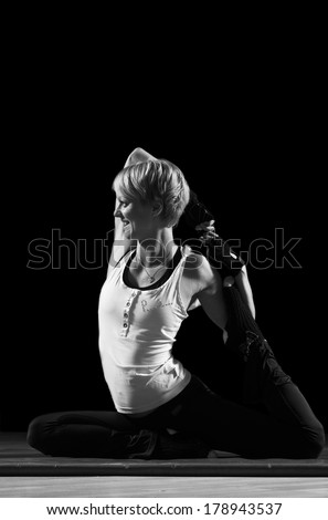 Happy young girl training yoga, black and white image